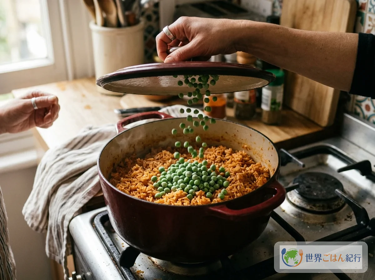 Scattering frozen green peas over the surface of the orange rice cooked over low heat